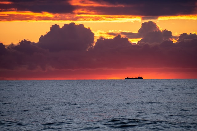 Силуэт морского судна на закате Изображение Силуэт морского судна на закате